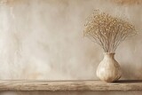 Vase with dried flowers on wooden shelf near beige wall