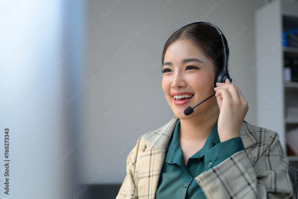 A woman wearing a headset is smiling while talking on the phone A woman wearing a headset is smiling while talking on the phone