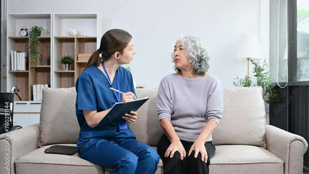 Young nurse helping elderly woman walk in the room, holding his hand, supporting. Treatment and rehabilitation after injury in assisted living senior care .. Young nurse helping elderly woman walk in the room, holding his hand, supporting. Treatment and rehabilitation after injury in assisted living senior care ..