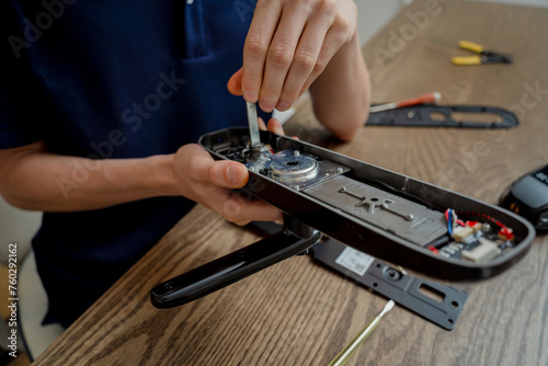 A technician assembles and installs smart electronic door lock for house protection