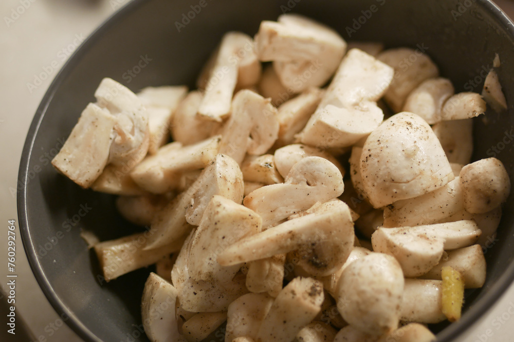 Fresh champignons mushroom in a white bowl on table Fresh champignons mushroom in a white bowl on table