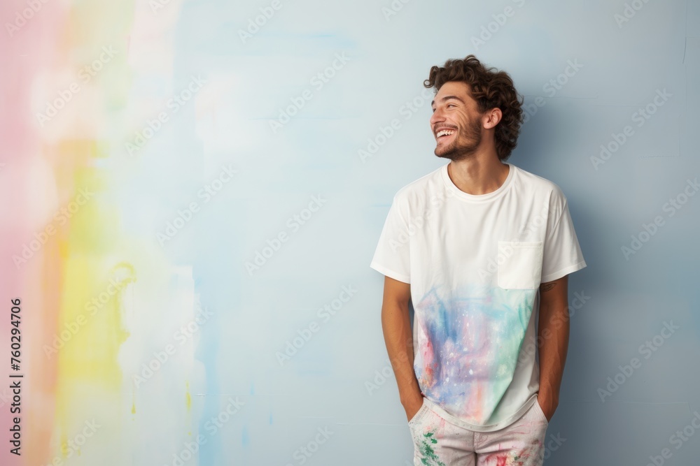 Joyful man in tie-dye shirt against pastel background, looking away with a bright smile, exuding creativity and happiness. Joyful man in tie-dye shirt against pastel background, looking away with a bright smile, exuding creativity and happiness.