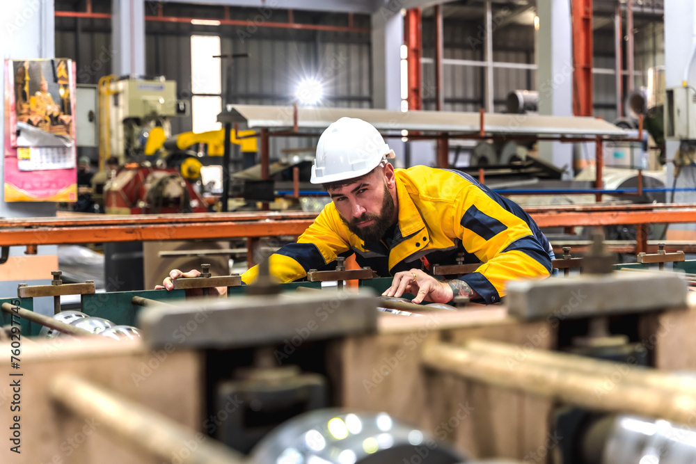 Fototapeta premium Expertise metal sheet engineer man working in metal manufacturing factory