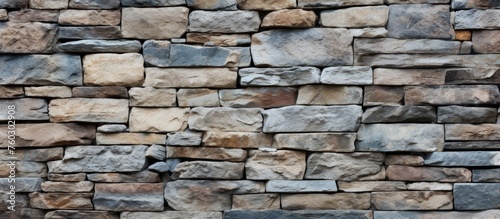 Rustic Stone Wall Featuring an Intricate Brown and Blue Pattern Background