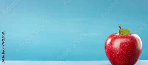 Vibrant Red Apple Placed on Elegant White Table in Bright Room Setting