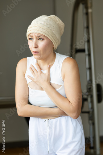 Unhealthy and sick woman having side effect of hair loss, nausea, fever, concept image for negative side effect or adverse effect after chemotherapy or radiation therapy for cancer treatment