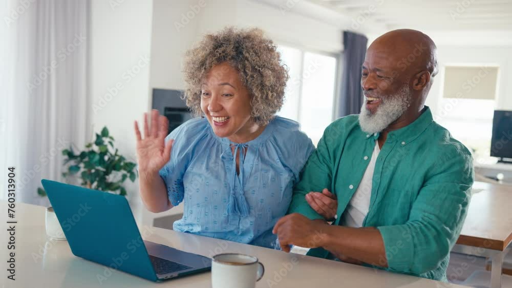 Excited mature couple with laptop at home making video call to family or friends - shot in real time Excited mature couple with laptop at home making video call to family or friends - shot in real time
