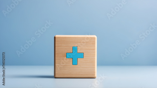 Health insurance icon on wooden block isolated on light blue background 