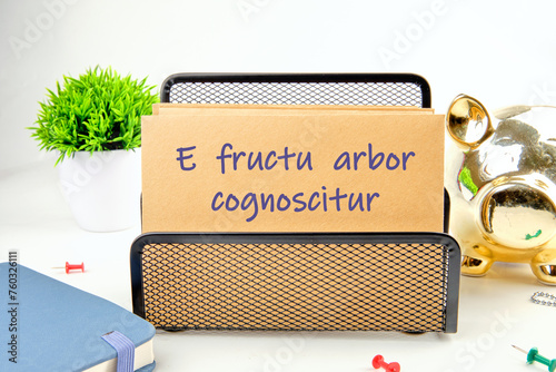 E fructu arbor cognoscitur the phrase in Latin translates as the Tree is known by its fruits on the mustard-colored card photo