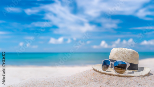 Sunglasses on beach, under sunny sky, by crystal blue water, amid golden sand, embodying summer vacation vibes