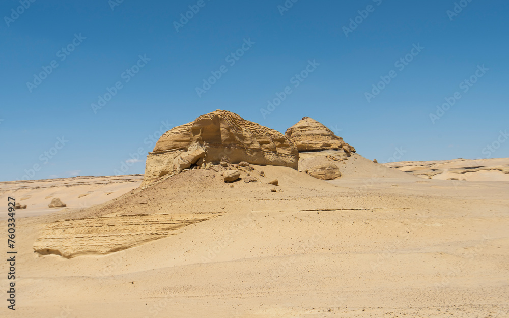 Barren desert landscape in hot climate with mountain rock formation Barren desert landscape in hot climate with mountain rock formation