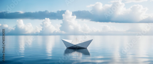 a paper boat on the beautiful sea photo