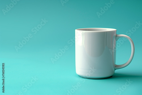 A plain white mug sits on a blue background © Jakraphong