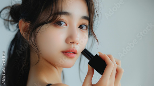 Asian Korean girl with natural beauty, holding a plain black perfume bottle, with a cheerful facial expression, Ai generated images