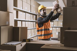 Warehouse clerk stacking boxes and checking orders