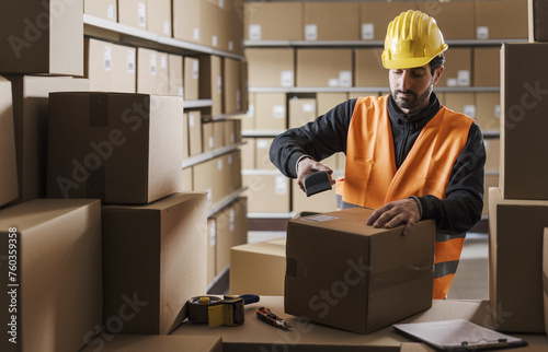Warehouse clerk scanning labels on packages
