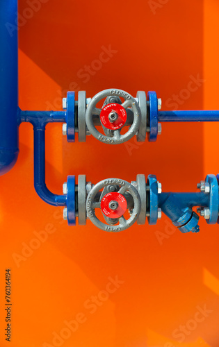 Pipes and valves comunications in color over metall wall photo