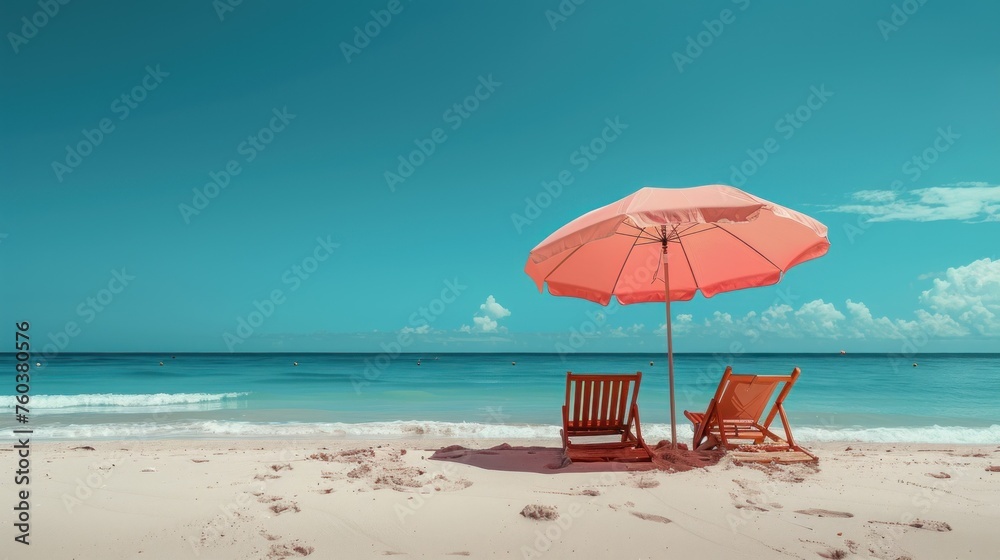 Two deck chairs under a pink umbrella on a bright blue beach