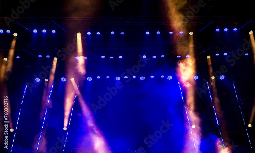 Stage light with colored spotlights and smoke.