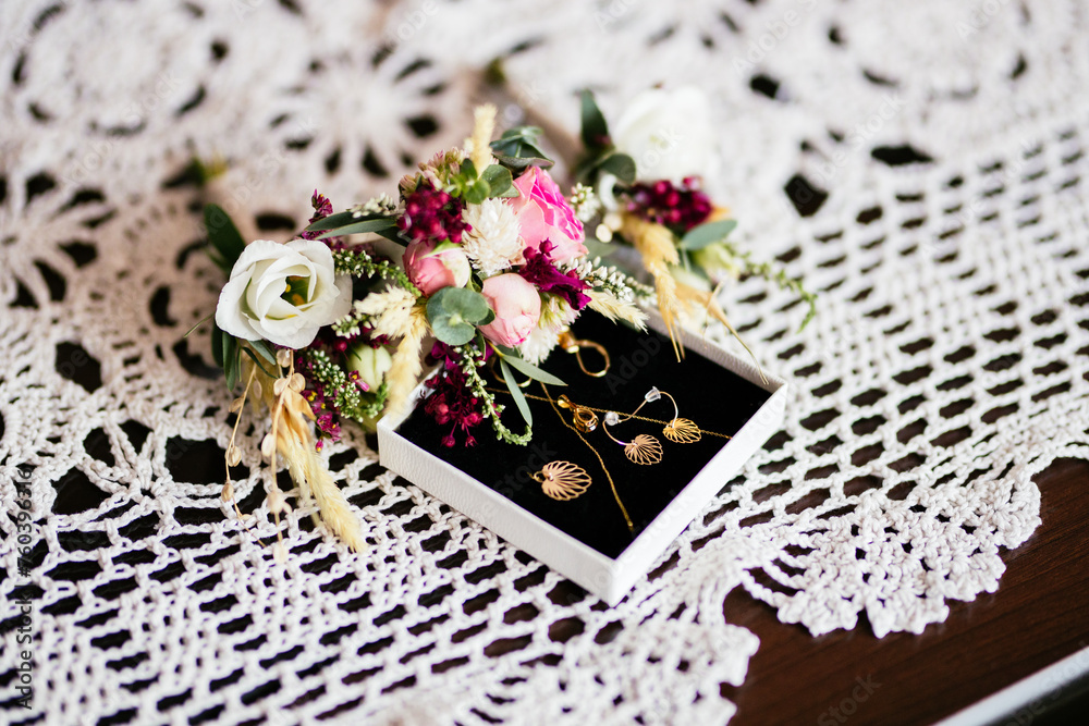 Bride wedding day preparation jewelry jewelry in box with flower bouquet