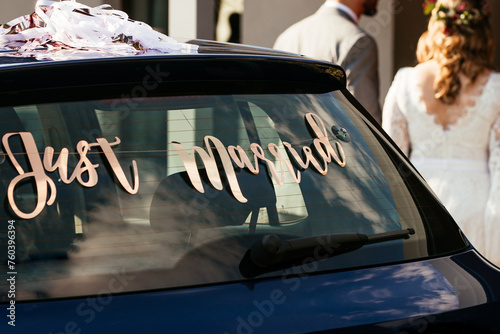 Golden Just Married Sign on a Car. Bride and Groom during Wedding. Elegant Wedding Celebration
