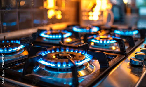 Modern gas stove burners ignited with blue flames, providing a close-up view of kitchen appliance efficiency and domestic culinary preparation