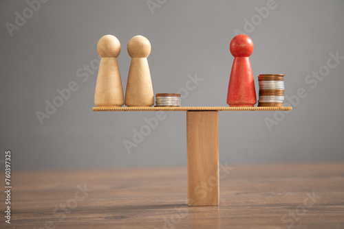 Wooden human figure, coins on the table. © andranik123