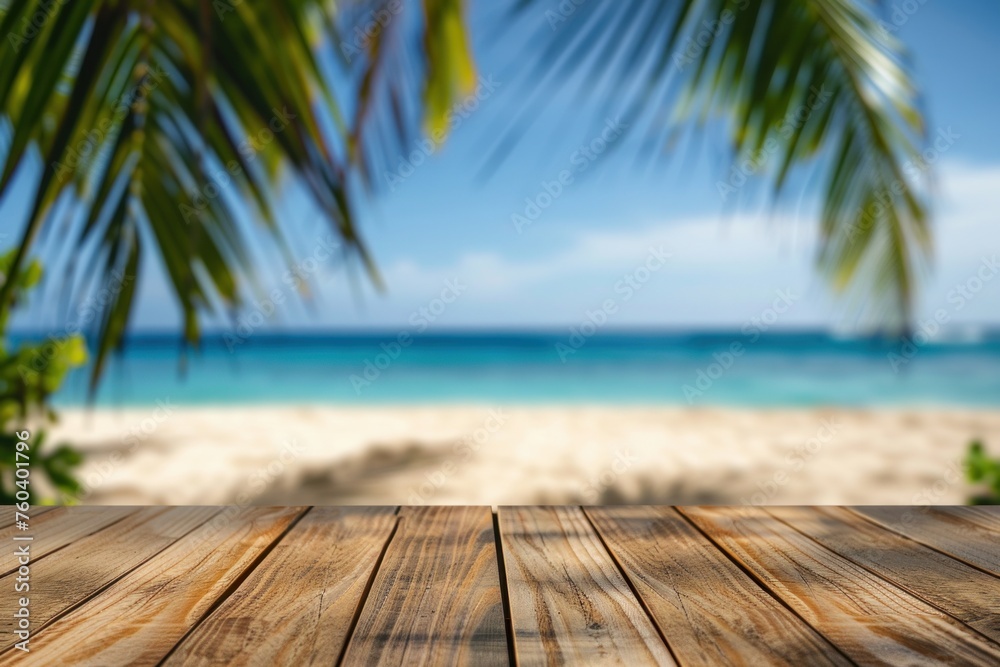 Wooden table with blurred bokeh light seascape and palm leaves at tropical beach background