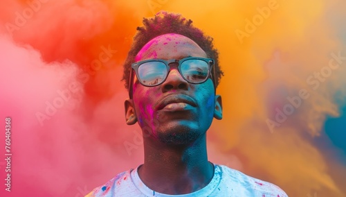 Portrait of young african american man with face covered in colored powder