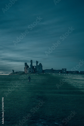 Dunstanburgh Castle at Night, Standing in Darkness Against the Northumberland Coast photo