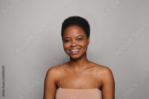 Happy wellness model woman with dark shiny skin and cute smile close-up portrait.