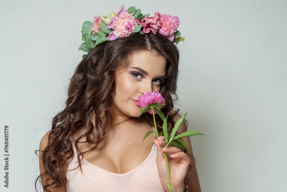Elegant healthy woman with clean fresh skin, wavy long hair and flower wreath, beauty portrait