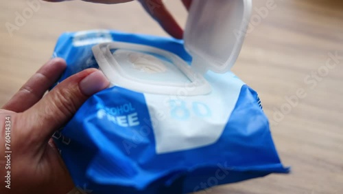 Unwrapping antibacterial wet wipes for hygiene. Embrace cleanliness and prioritize hygiene with this convenient solution. Ensure optimal hygiene with antibacterial wipes for effective sanitation 