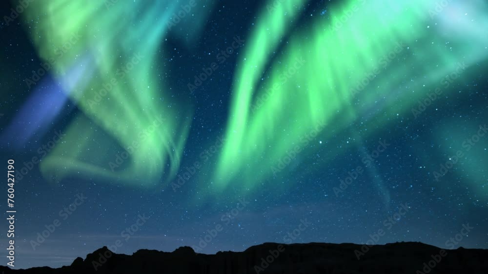Aurora Green and Starry Sky Over Canyon Tilt Down