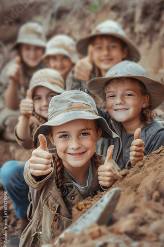 Group of children smiling, having thumbs up doing their dream job as Archeologists at the site with excavations in the background. Concept of Creativity, Happiness, Dream come true and Teamwork.