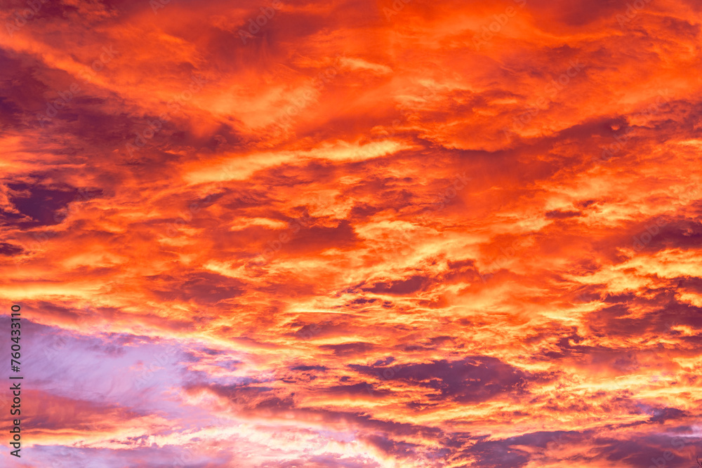 Sunset with cirrus clouds, beautiful cloud patterns at dusk, sunrise, orange clouds in the sky, sky background. Orange clouds and sky at sunset
