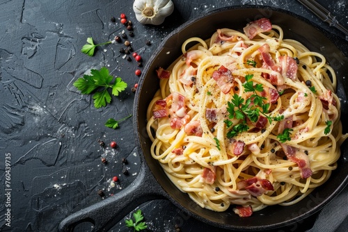 Delicious Spaghetti Carbonara in Cast Iron Pan on Black Background
