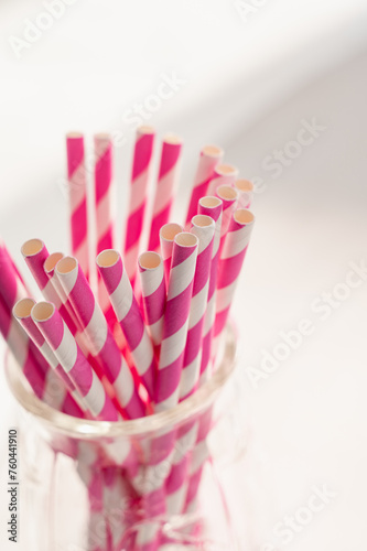 Pink paper straws on white background