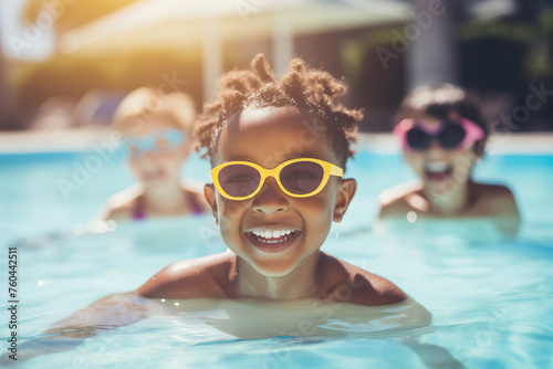 Happy African American joyful child swimming in sunny pool, sharing fun moment with friends, sunlight.