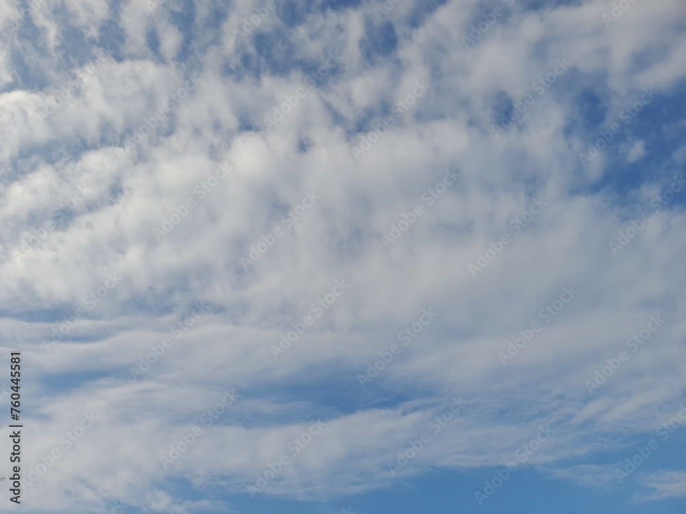 Beautiful white clouds on deep blue sky background. Large bright soft fluffy clouds are cover the entire blue sky. Skyscape on Lombok Island, Indonesia