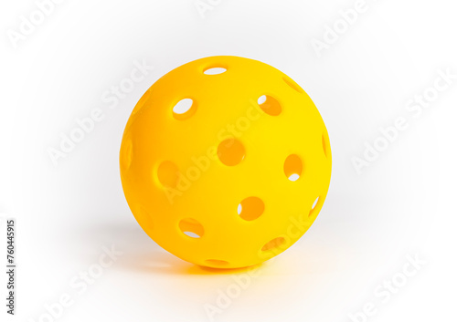 A yellow pickleball ball isolated on a white background