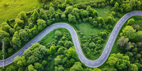 Aerial view of a winding asphalt road in the forest