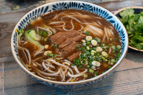 Closeup photo of beef rice noodle (pho), taken in a restaurant