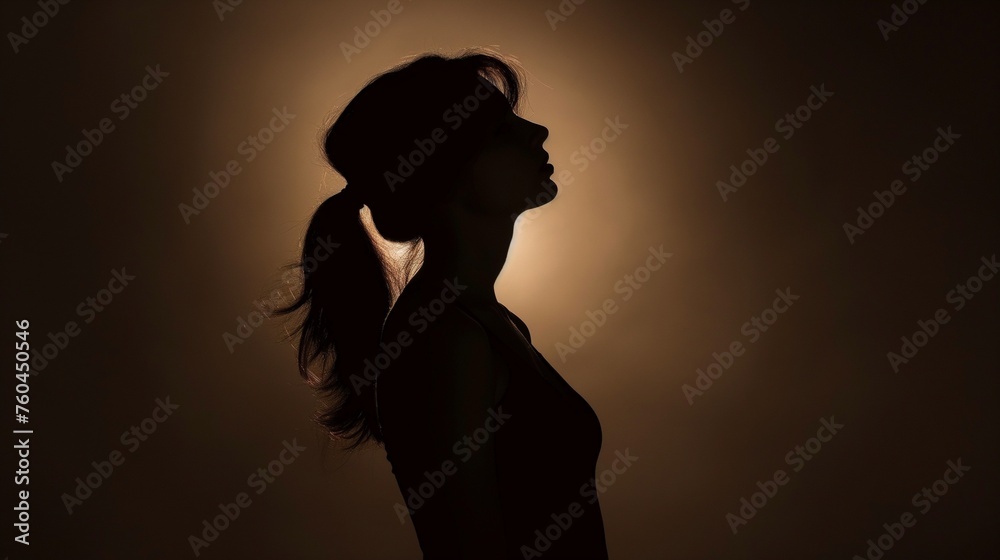 The magnetic charm of a girl model in an HD photograph, her silhouette against a solid background creating an aura of sophistication.