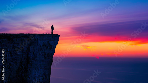 A lone figure stands at the edge of a cliff, silhouetted against a sunset sky, contemplating the vastness of the landscape below High detailed and high resolution smooth and high quality