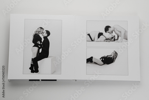 The pages of a photo book with a photo of a pregnant blonde and a man.  © andrey