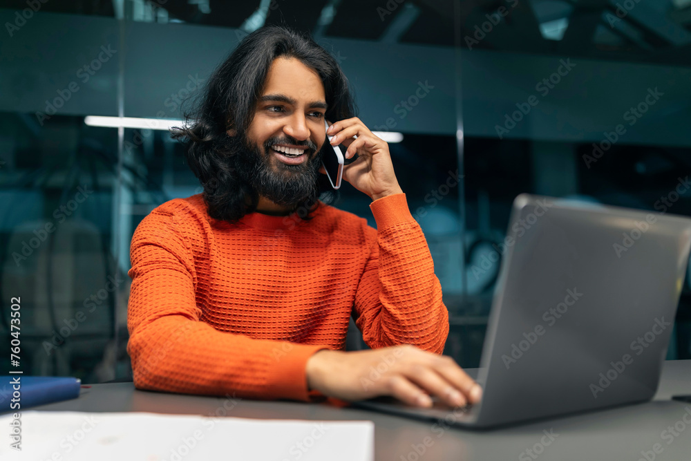 Eastern entrepreneur have business call on smartphone, office interior