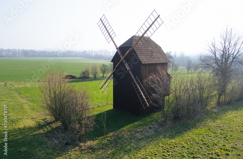 Old wooden windmill in the field. Springtime atmosphere. Historical photograph. Europe, Czech Republic 