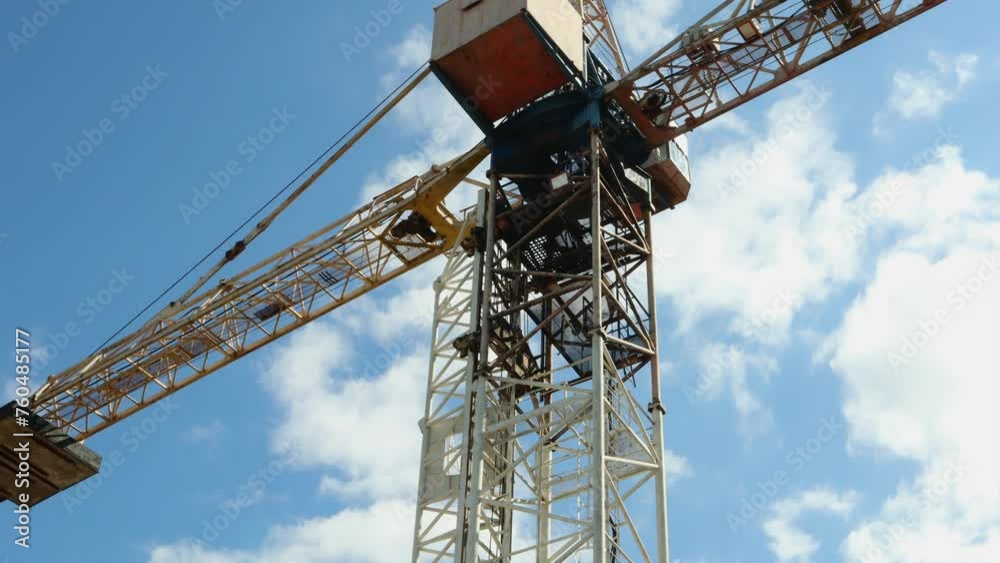 Time lapse of bright white clouds, large construction crane, construction or renovation concept Time lapse of bright white clouds, large construction crane, construction or renovation concept