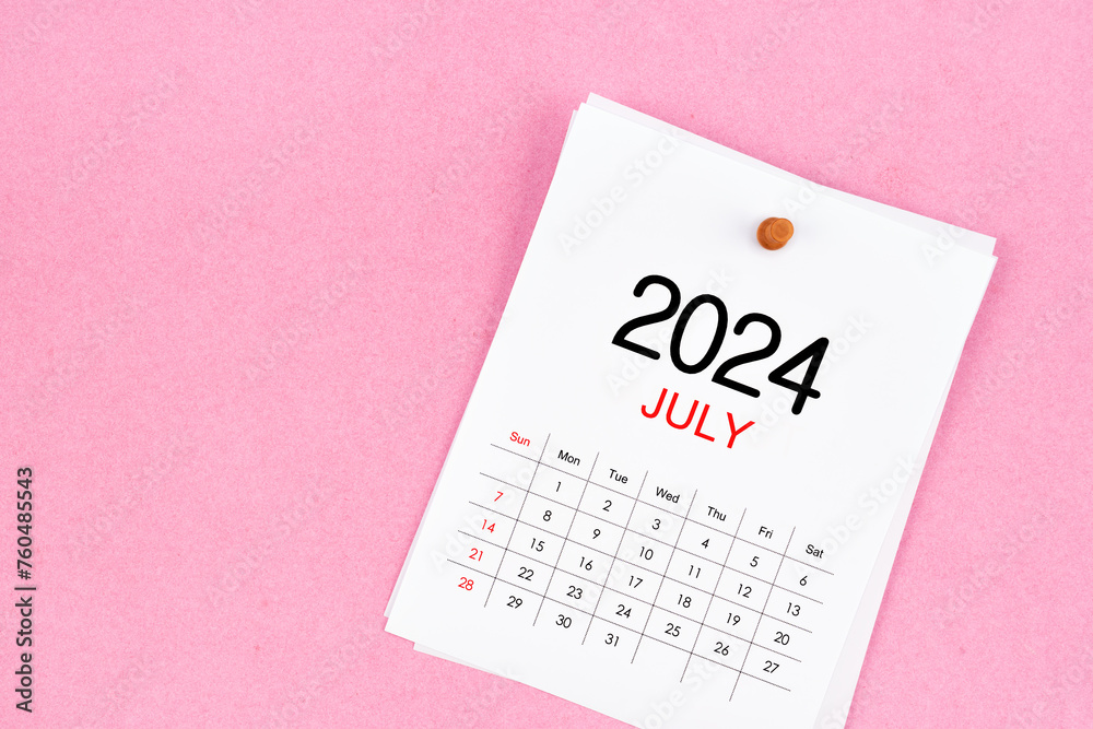 July 2024 calendar page and wooden push pin on pink background. July 2024 calendar page and wooden push pin on pink background.
